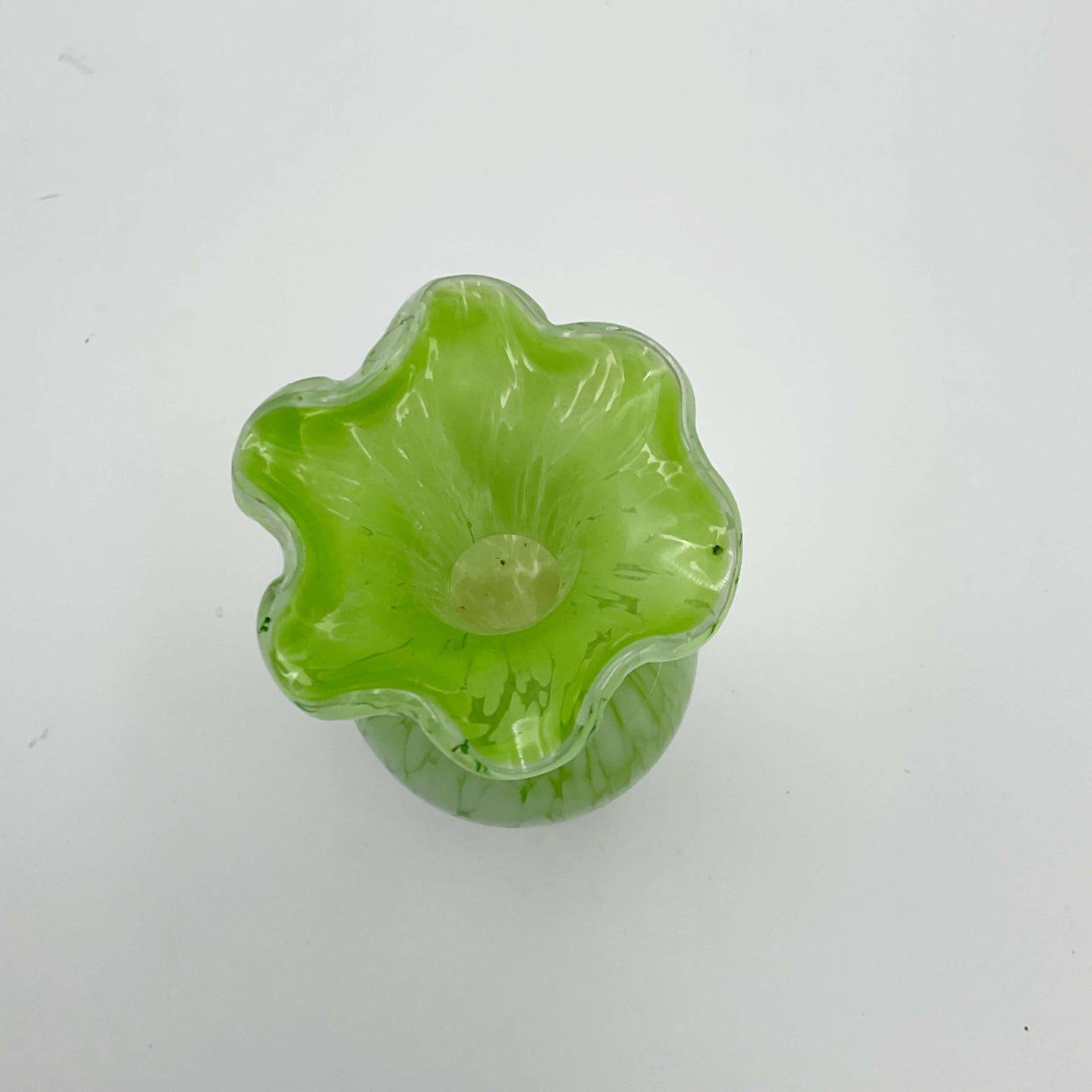 Top view of Green and white Murano glass bud vase from the 1960s on a white background 