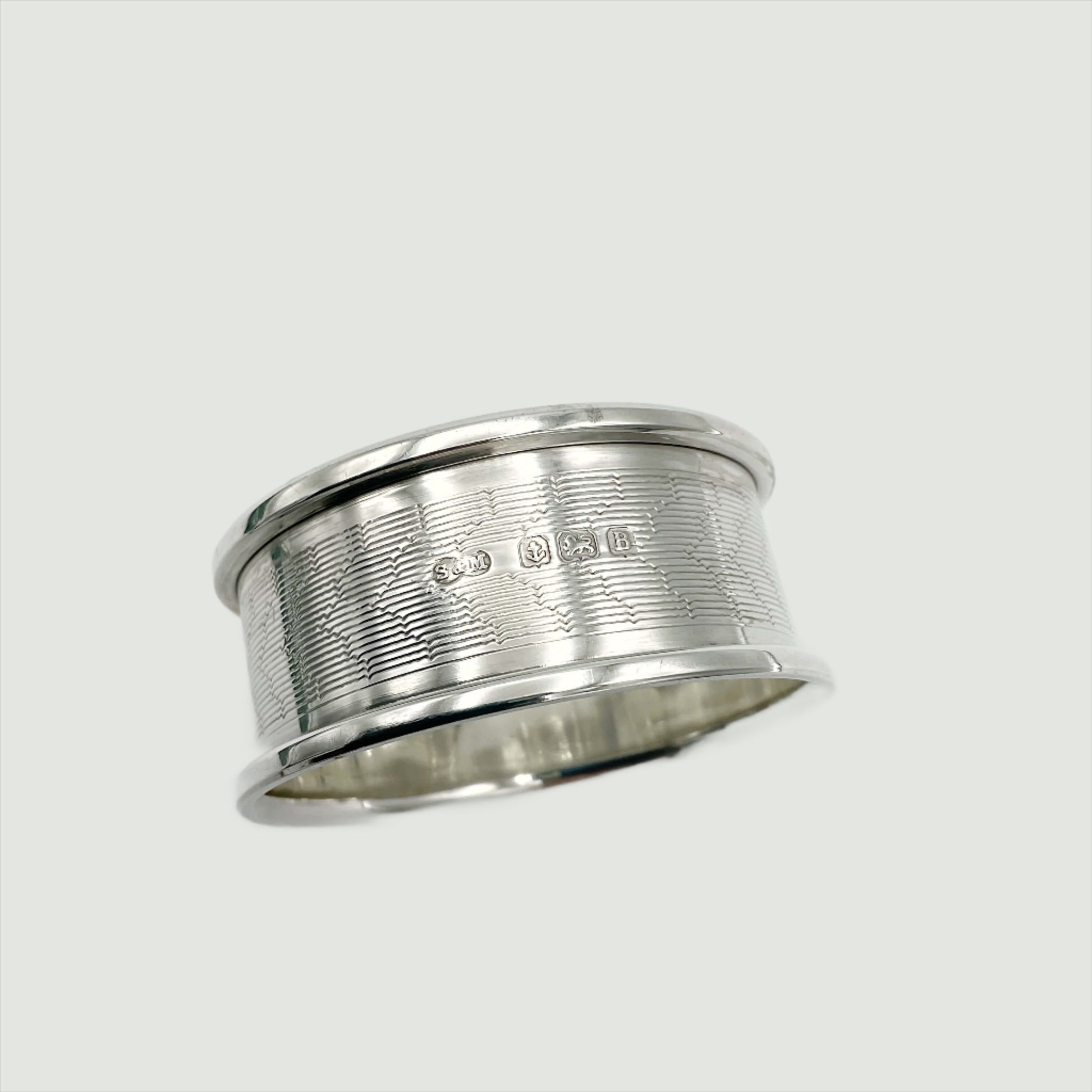 Silver napkin ring with hallmarks and maker’s marks