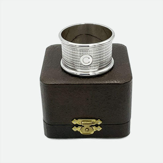 Vintage silver napkin ring sitting on a brown gift box