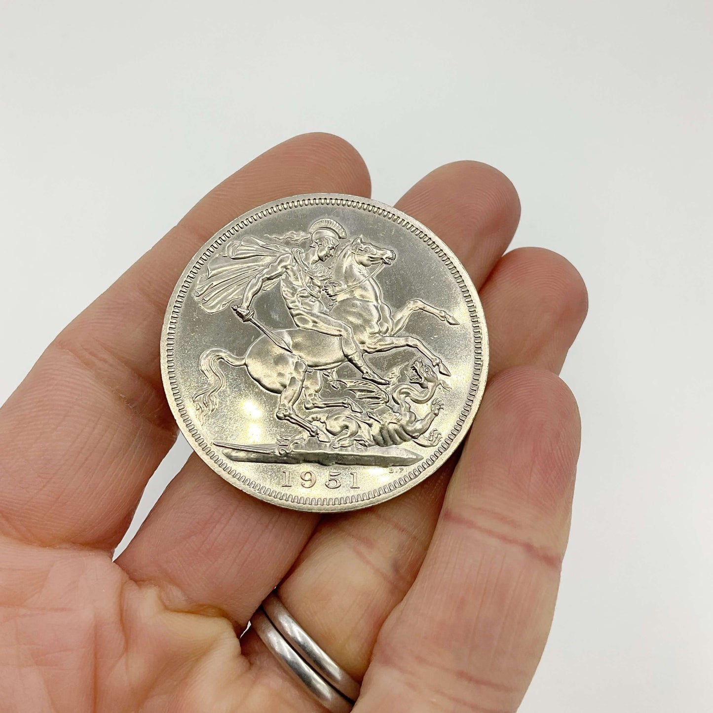 Festival of Britain coin Held in a hand