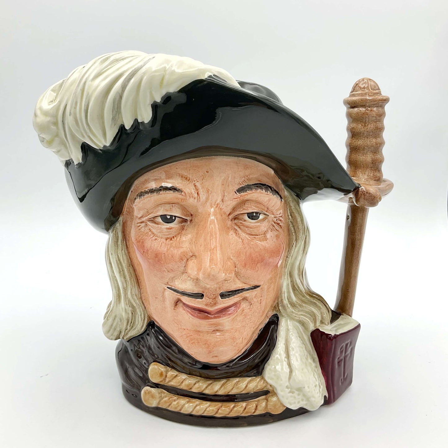 Large Aramis China collectible toby jug on plain background.