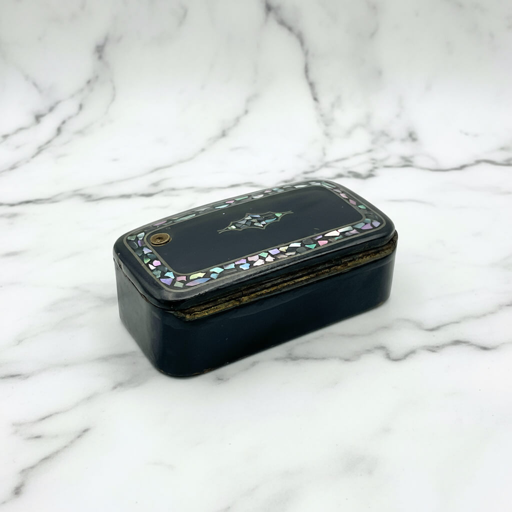 Back view of Antique black lacquer snuff box with multicoloured shell inlay showing a hinge