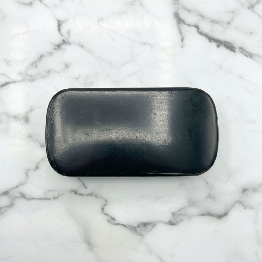 Black base of snuff box on a marble background 