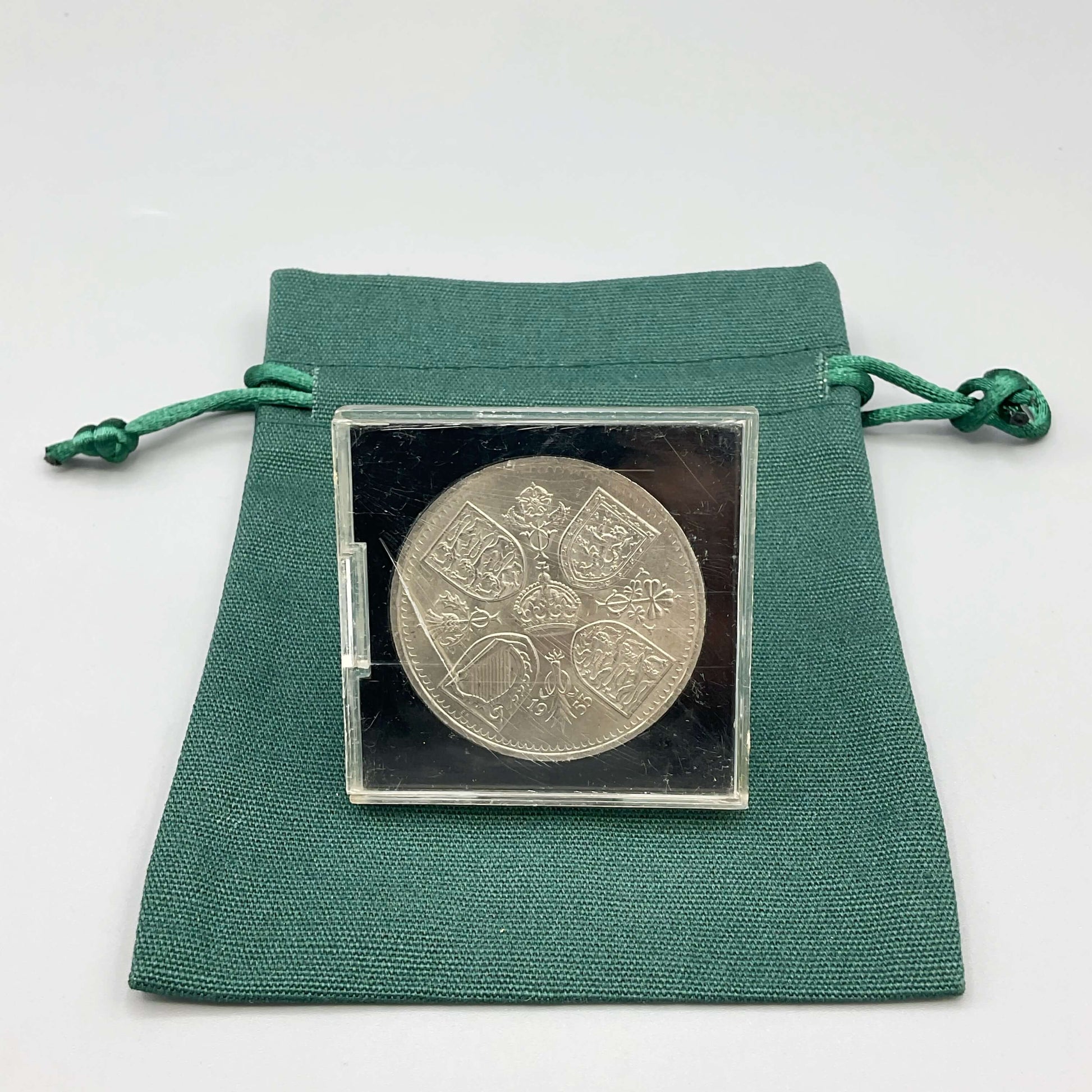 Queen Elizabeth II Coronation Five Shilling Coin in a Perspex Case On a green gift bag