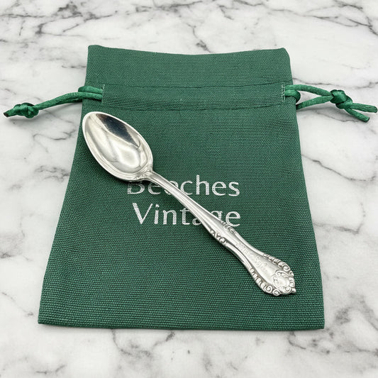 silver plated spoon on a green bag