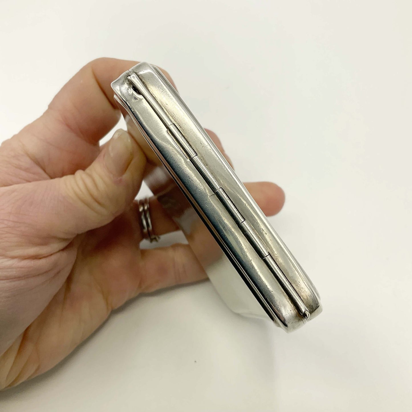 Hinge view of Silver Cigarette Case in a hand