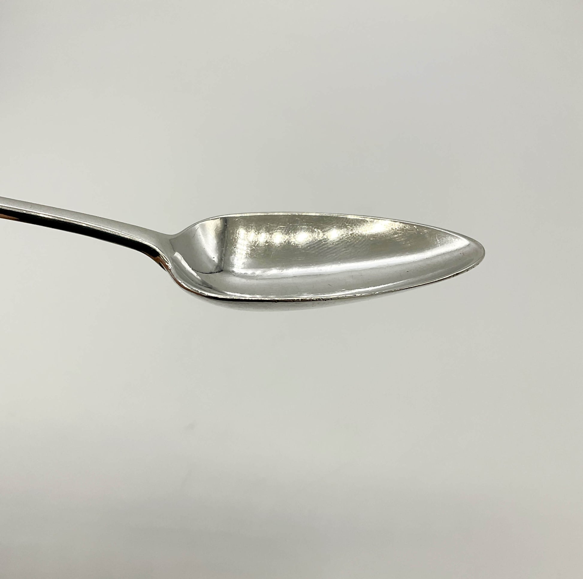 Antique Silver Dessert Spoon hbowl on a white background 