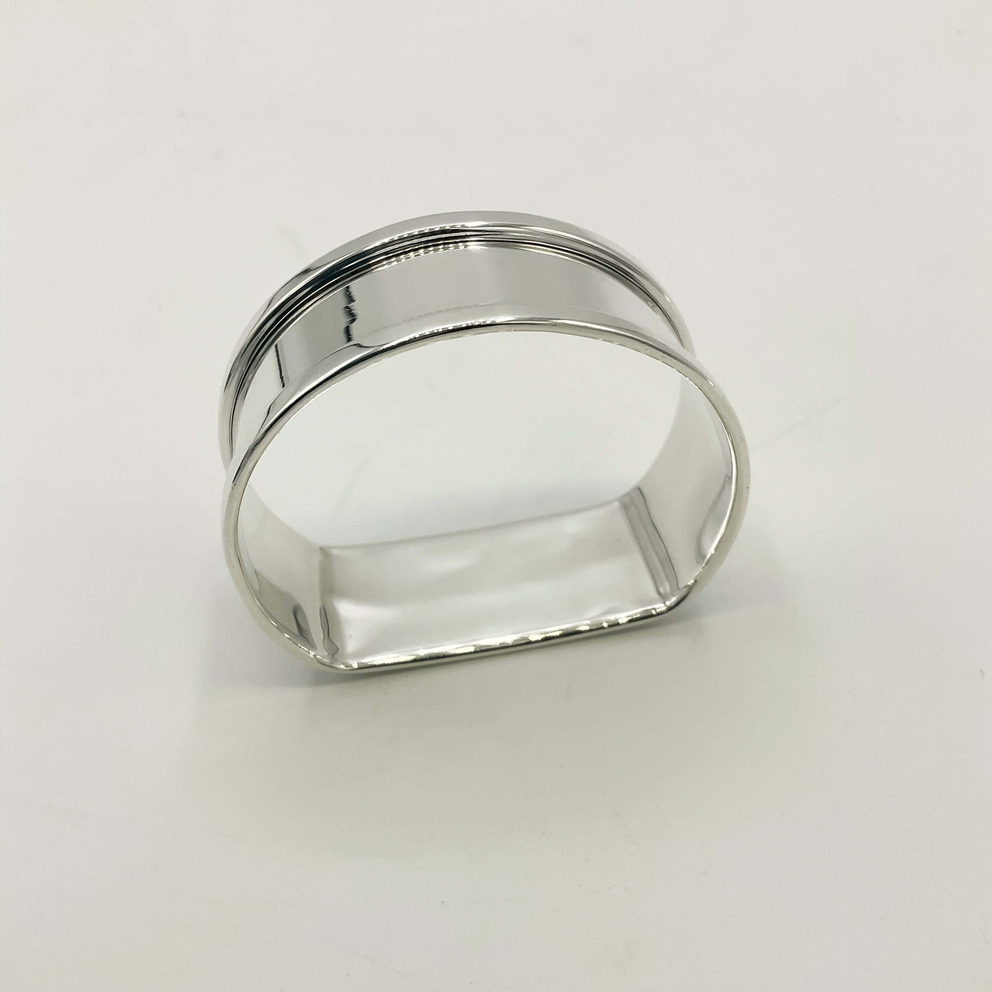 Side view of a Vintage silver napkin ring on a white background 