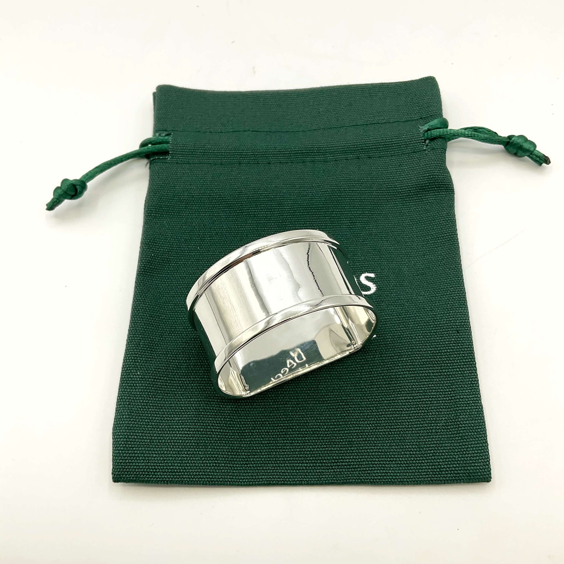 Vintage Silver napkin ring on a green gift bag