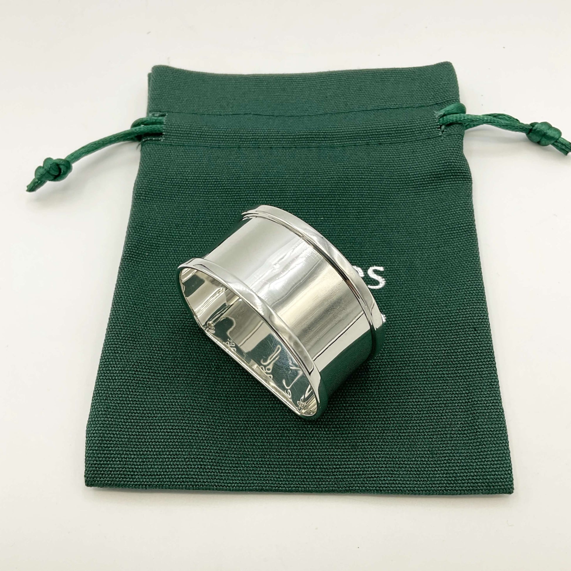 Vintage Silver napkin ring on a green gift bag