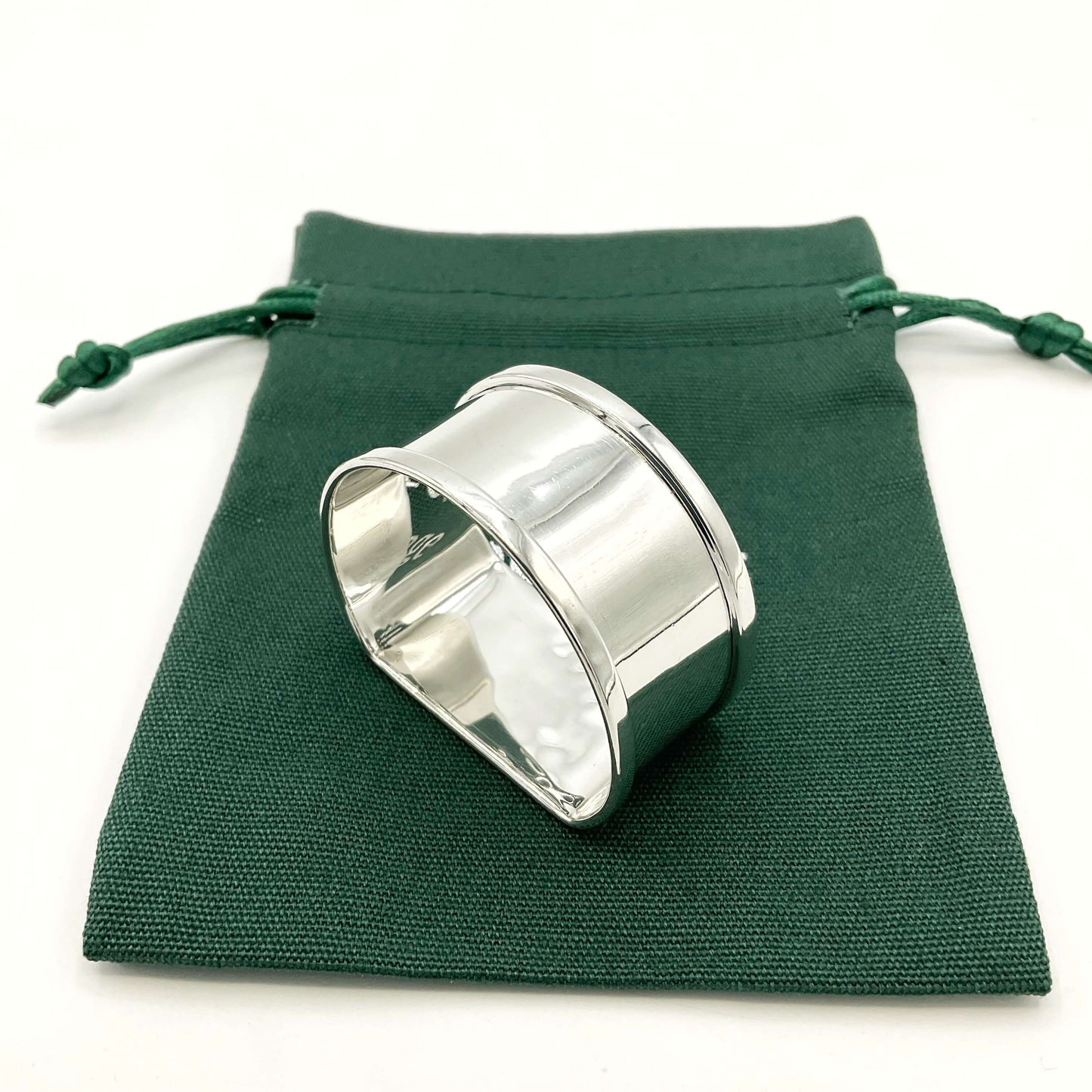 Vintage Silver napkin ring on a green gift bag