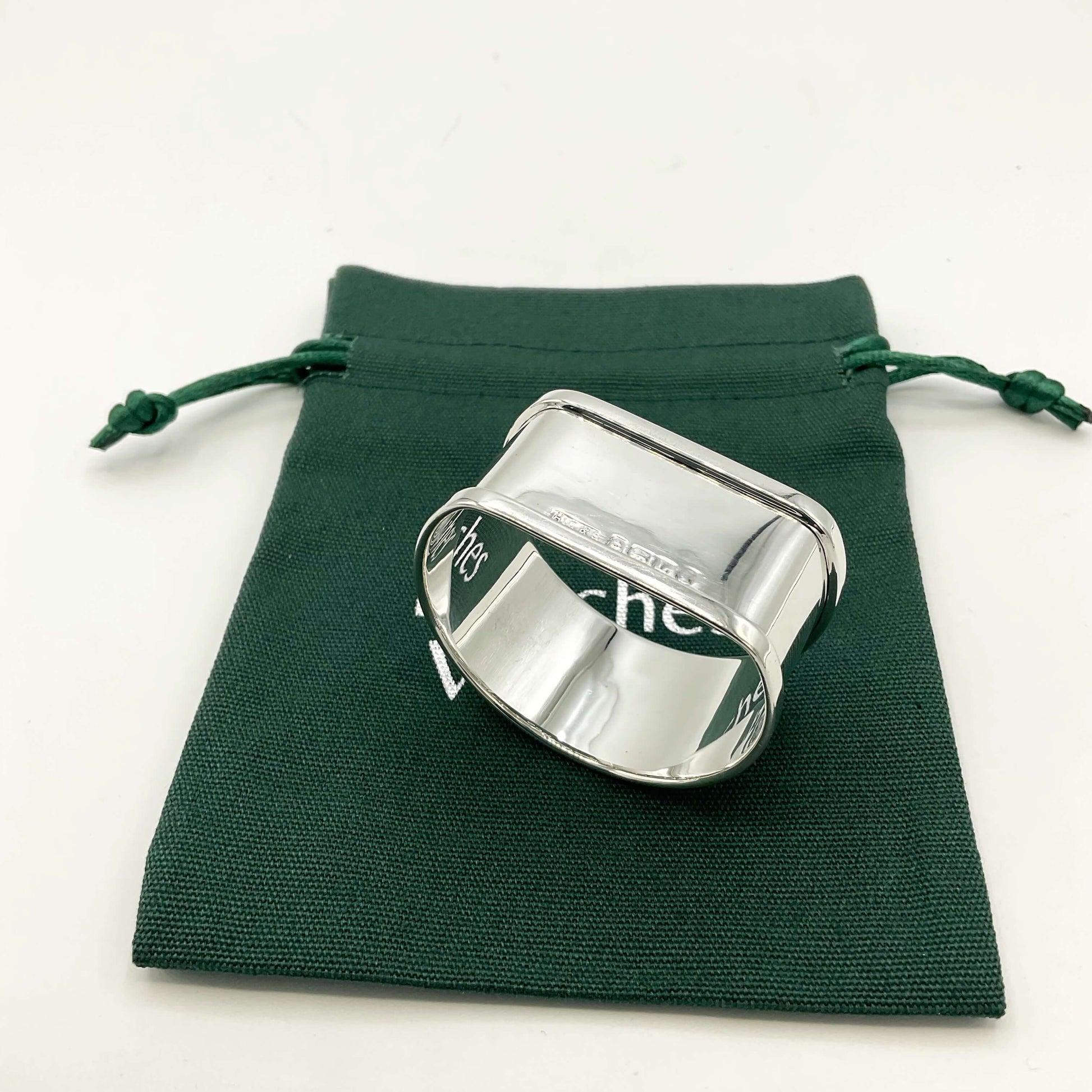 Upside down view of Vintage Silver napkin ring on a green gift bag