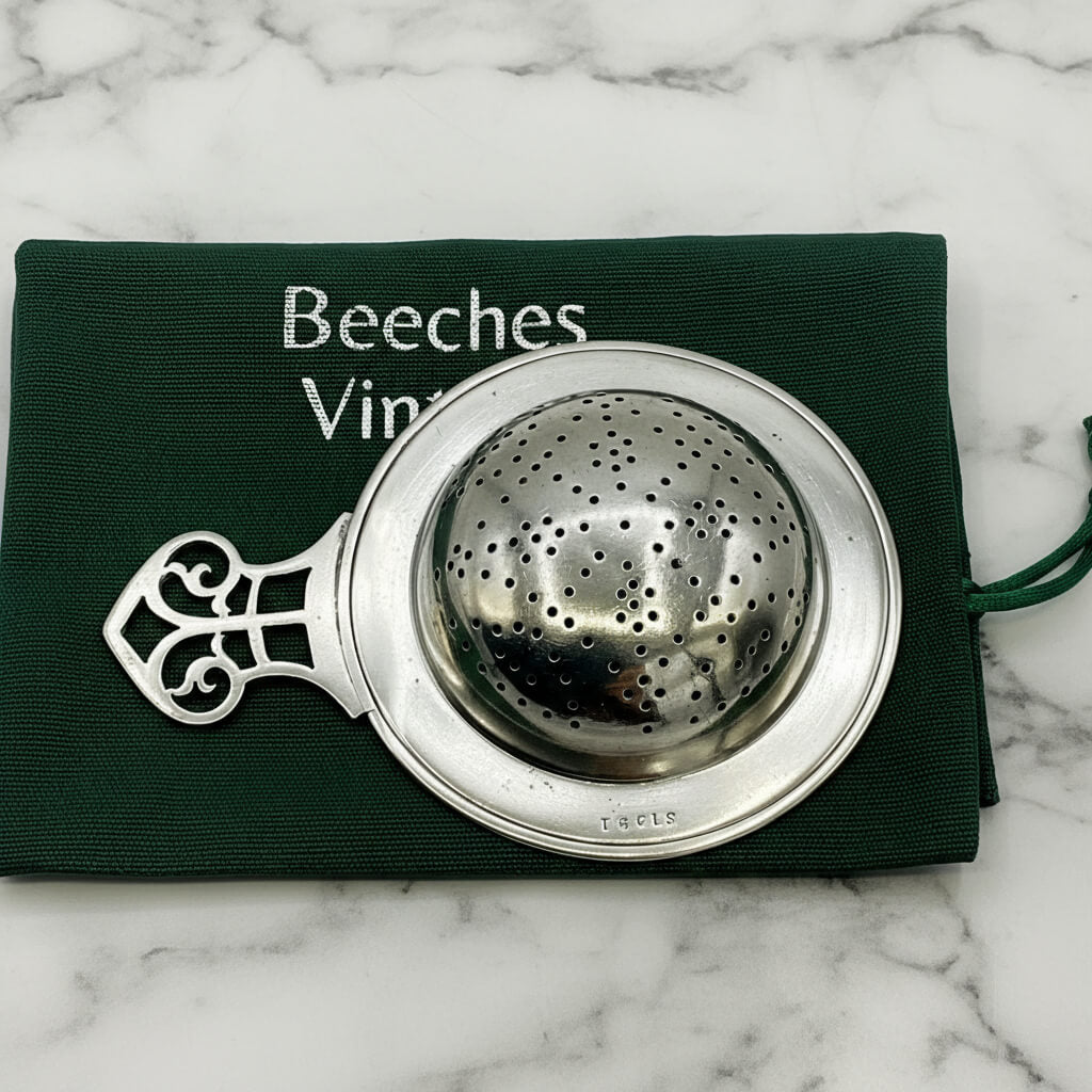 Antique 1925 sterling silver tea strainer with ornate design, made by Beeches Vintage, showcasing intricate craftsmanship.