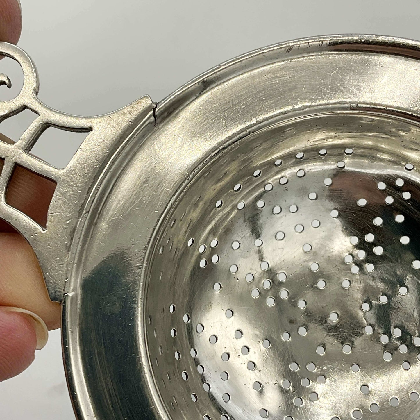 Antique 1925 sterling silver tea strainer with intricate design, vintage Beeches Silver brand, displayed on a white background.