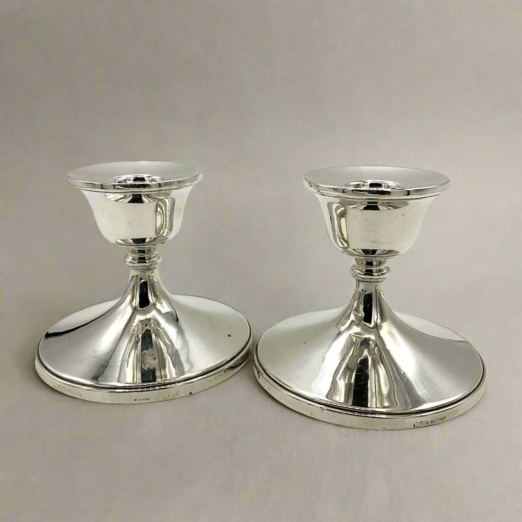 Pair of silver candlestick holders on a on a white background 