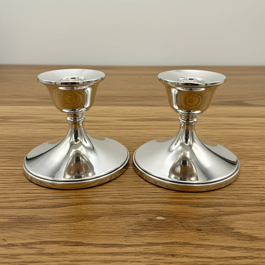 Pair of silver candlestick holders on a on a white background 