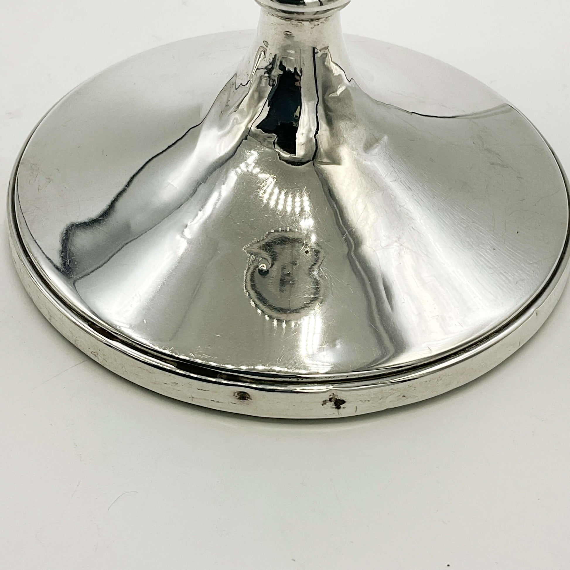 Small dents on the bottom rims of candlesticks 