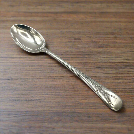 Silver coffee spoon on a wooden table