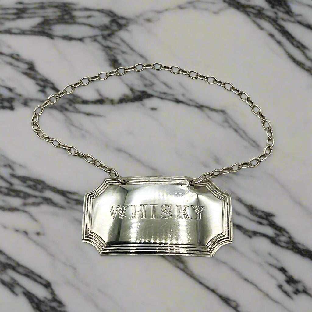 Silver Whisky decanter label on a marble worktop