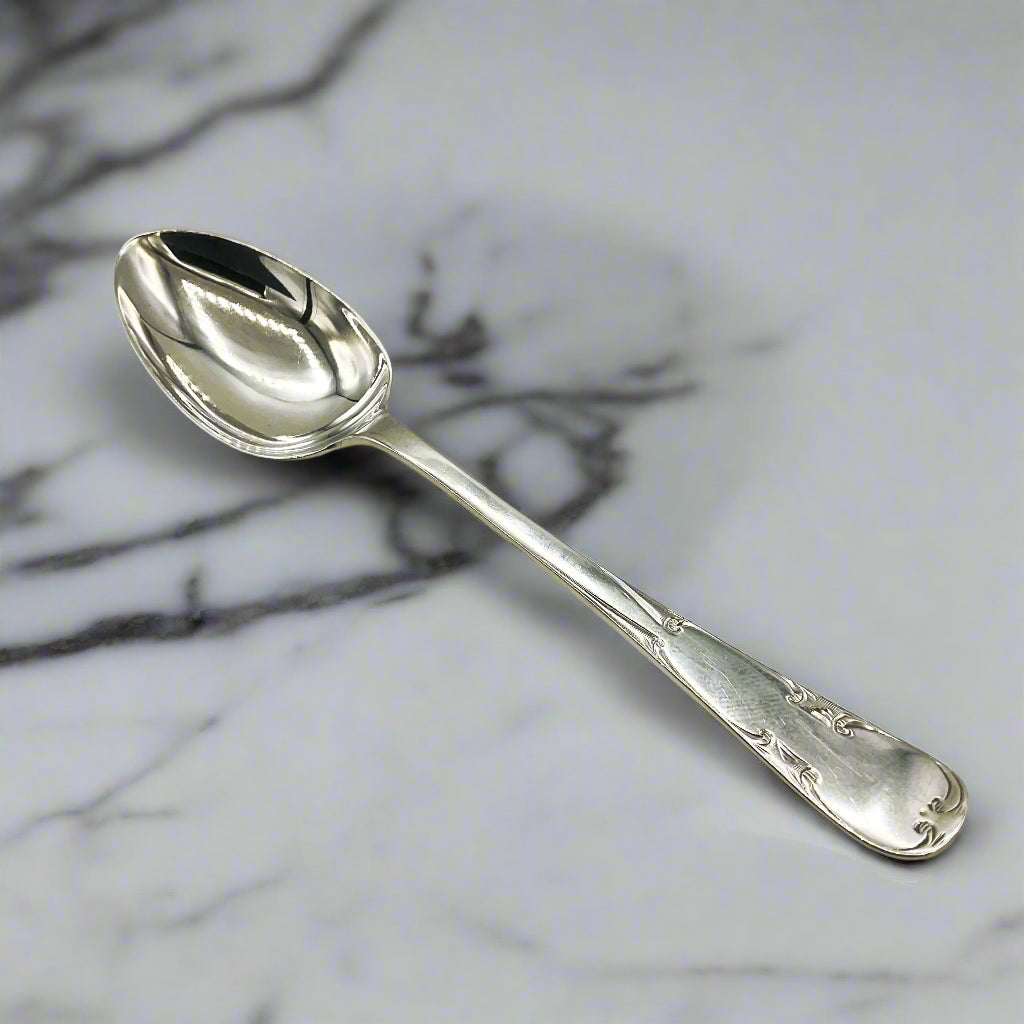 Silver teaspoon on  a marble worktop
