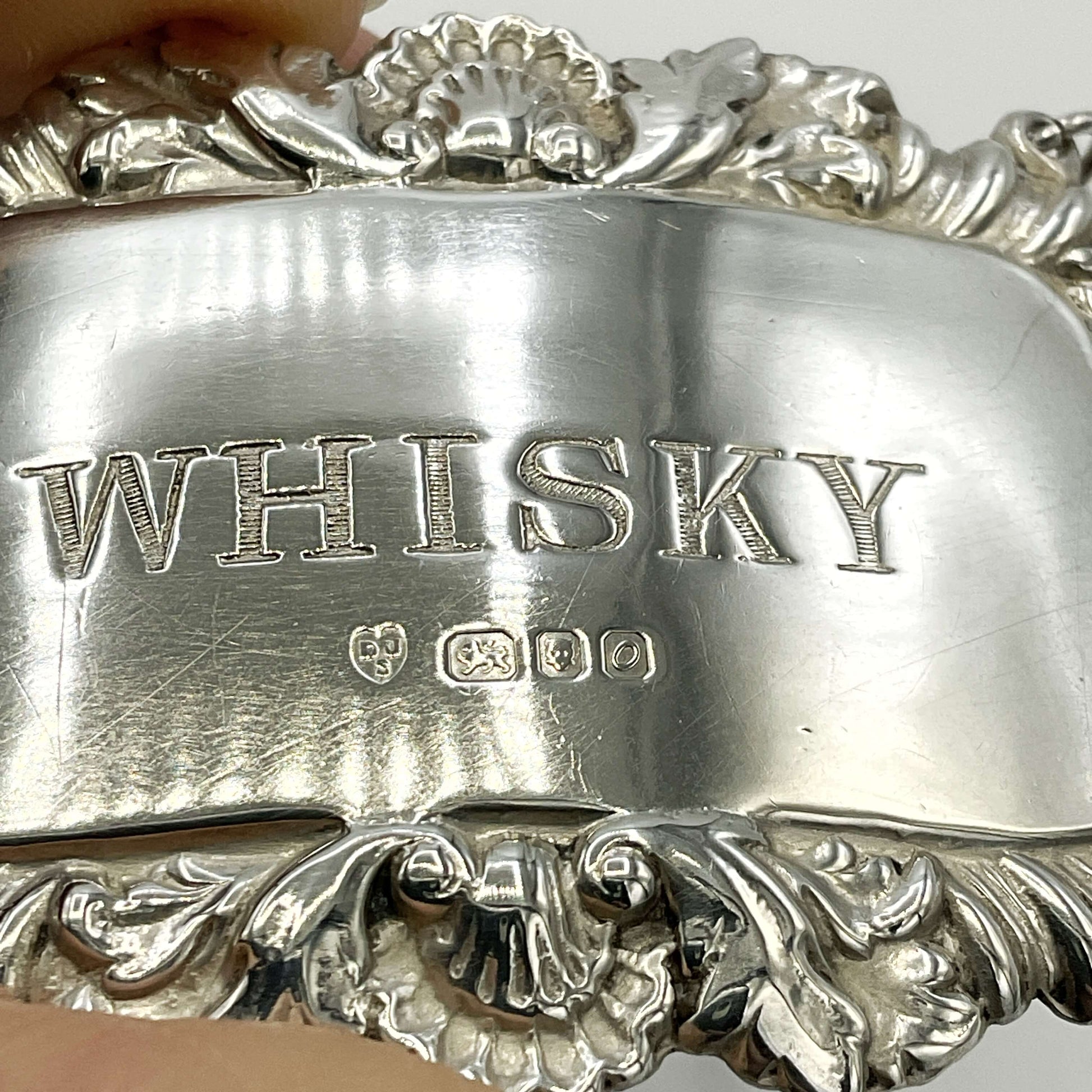 Close up of whisky decanter label showing hallmarks