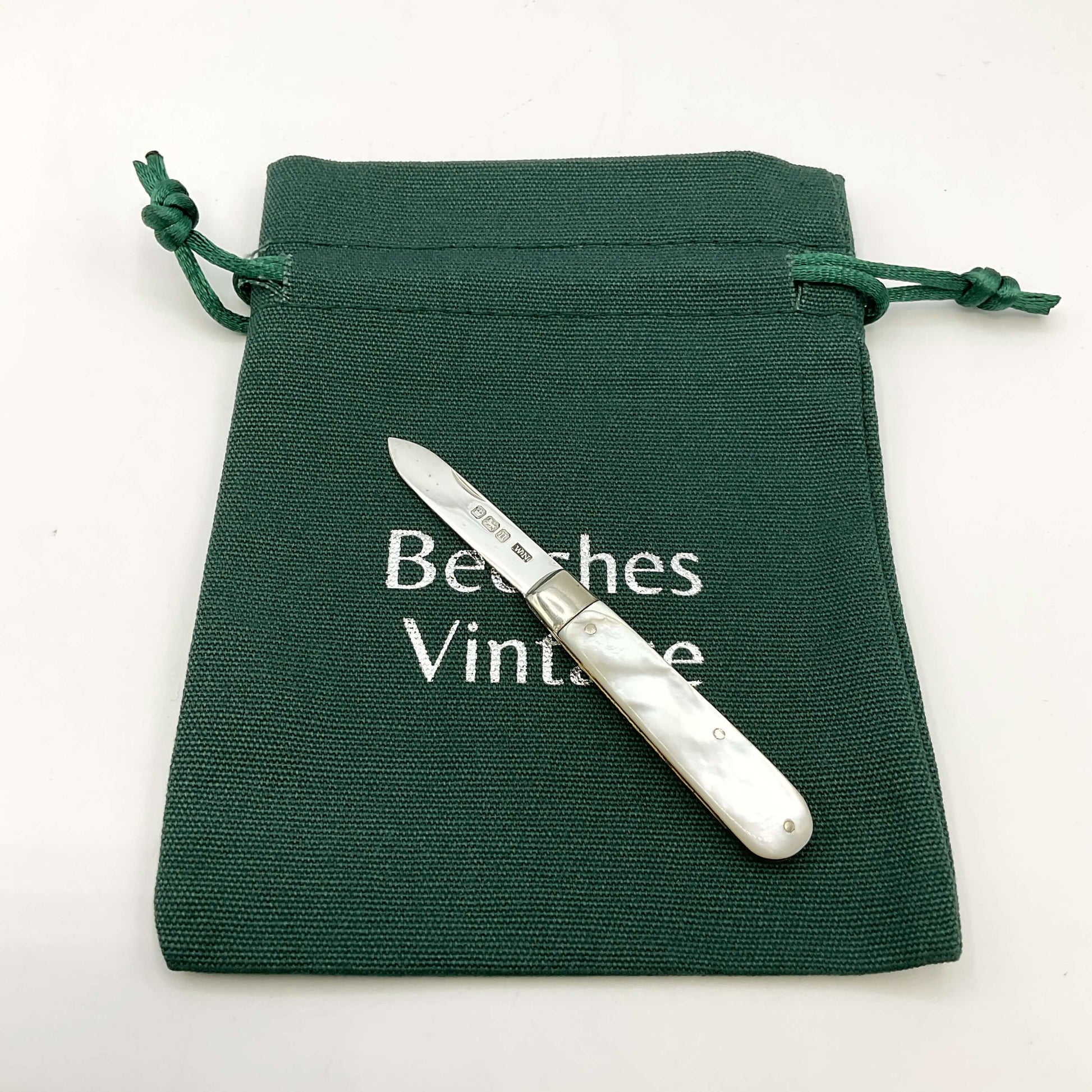 Silver fruit knife Ona green gift bag and white background 