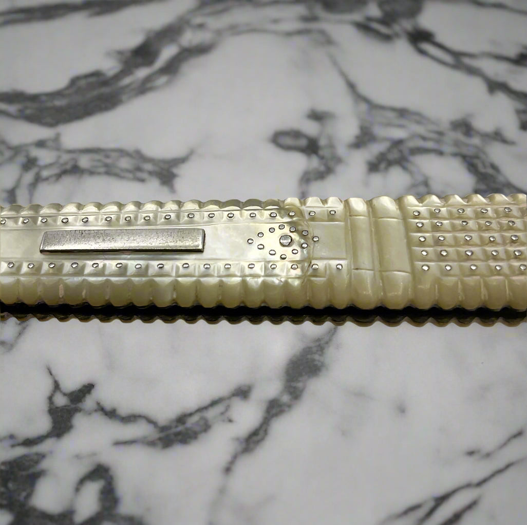 Antique silver fruit knife Showing a crack in the handle on a marble worktop 
