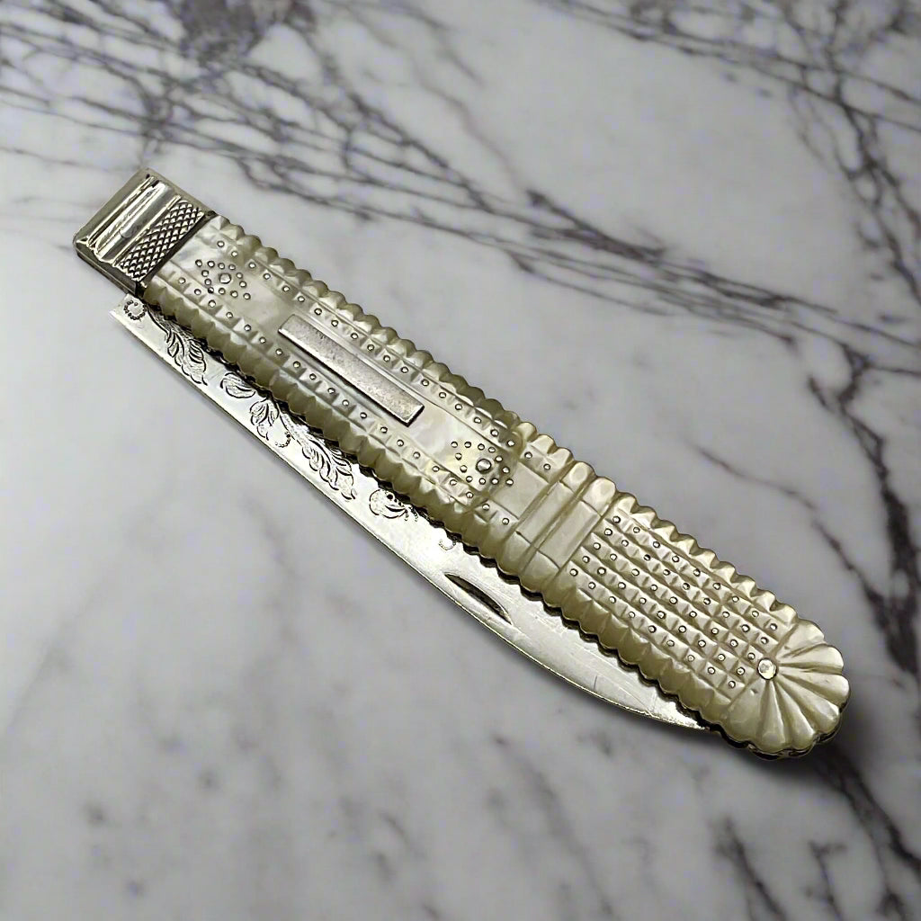 Antique silver fruit knife On a marble worktop