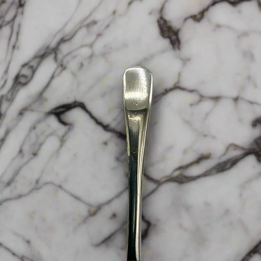 Silver spoon on a marble worktop