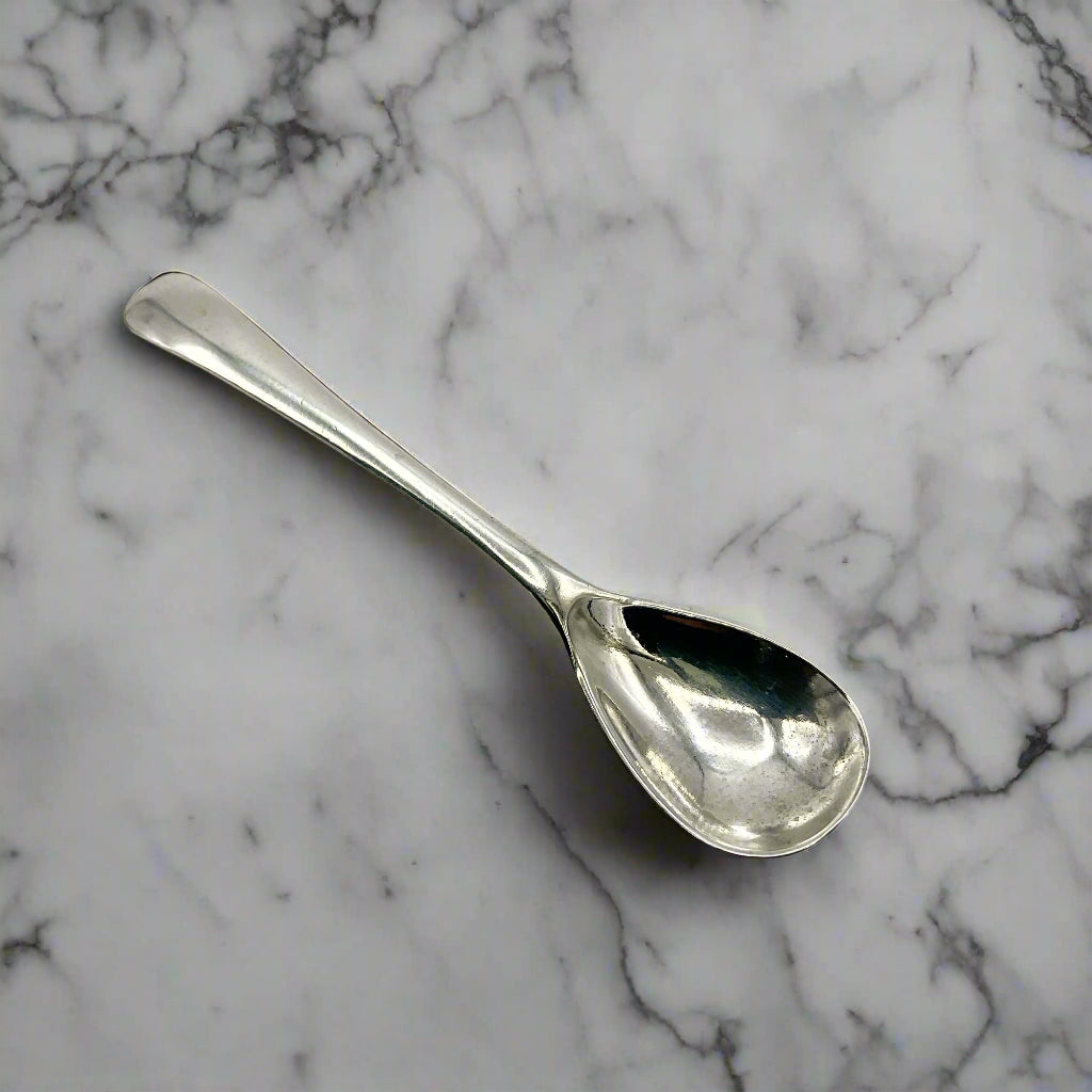 Silver spoon on a marble worktop
