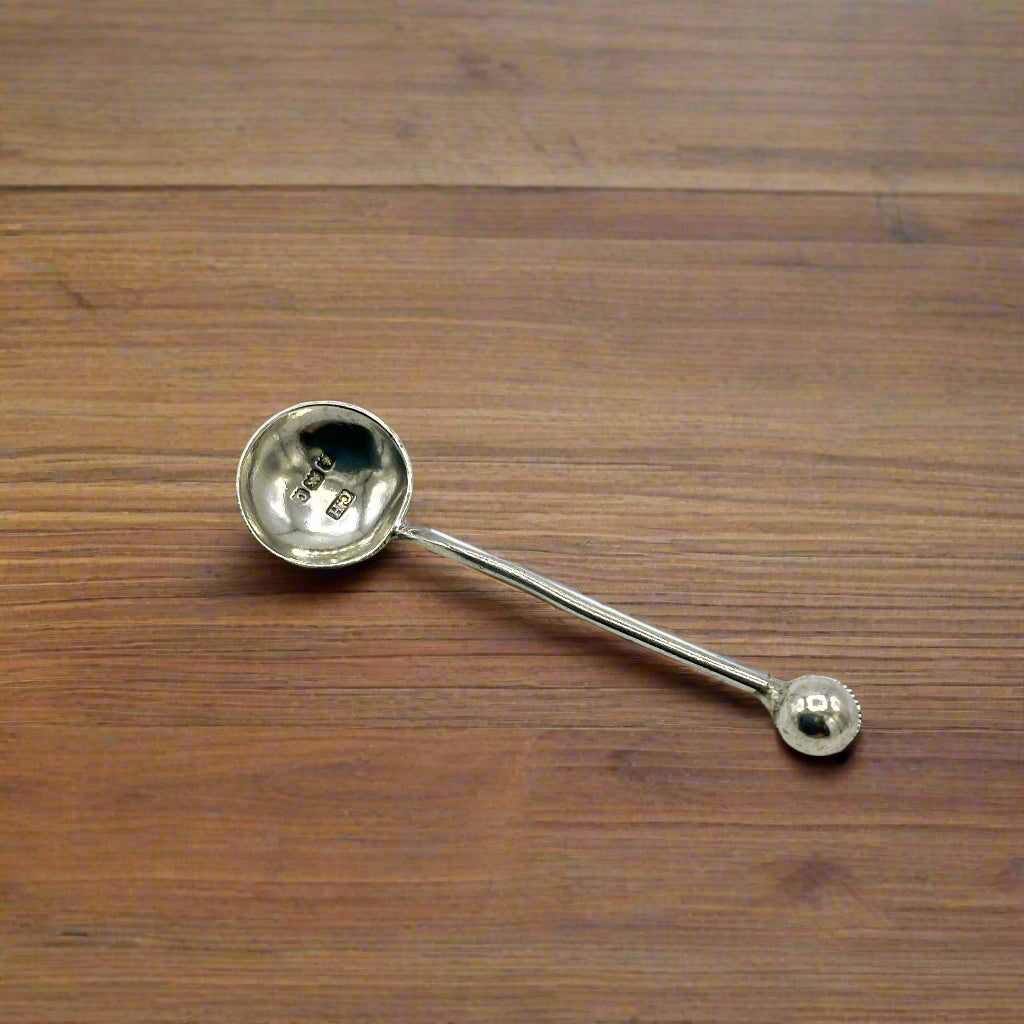 Silver salt spoon on a wood table