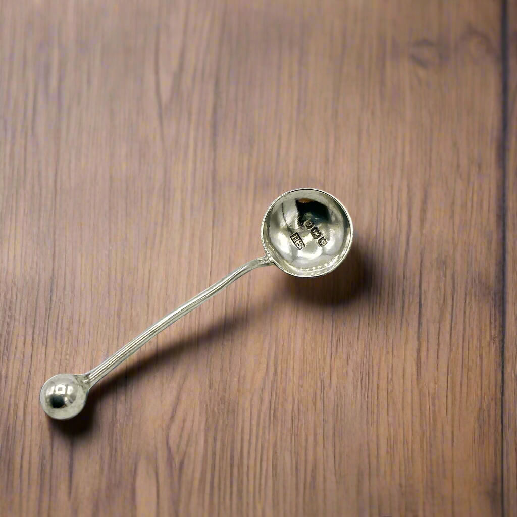 Silver ladle on a wooden surface