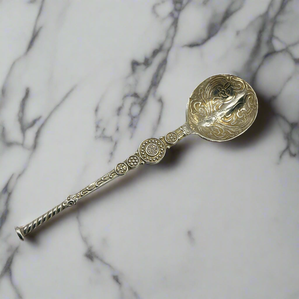 Decorative silver spoon on a marble worktop