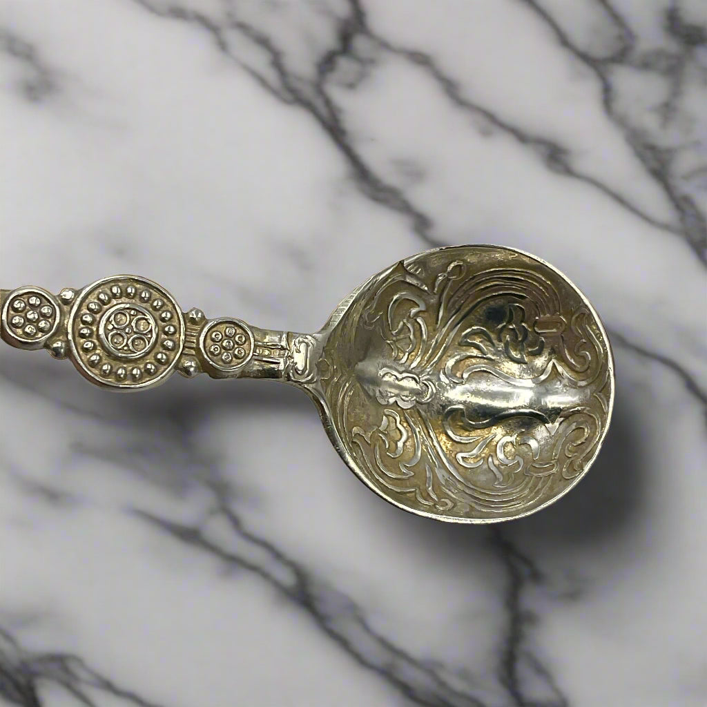 Decorative silver spoon on a marble background 