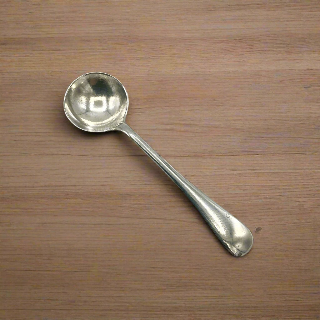 Silver spoon on a wood table