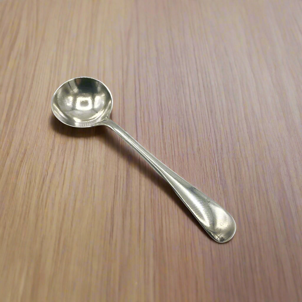 Silver spoon on a wood table