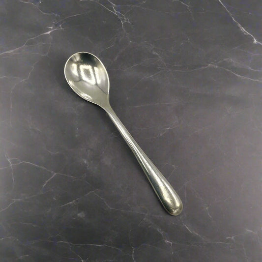 Silver spoon on a granite worktop