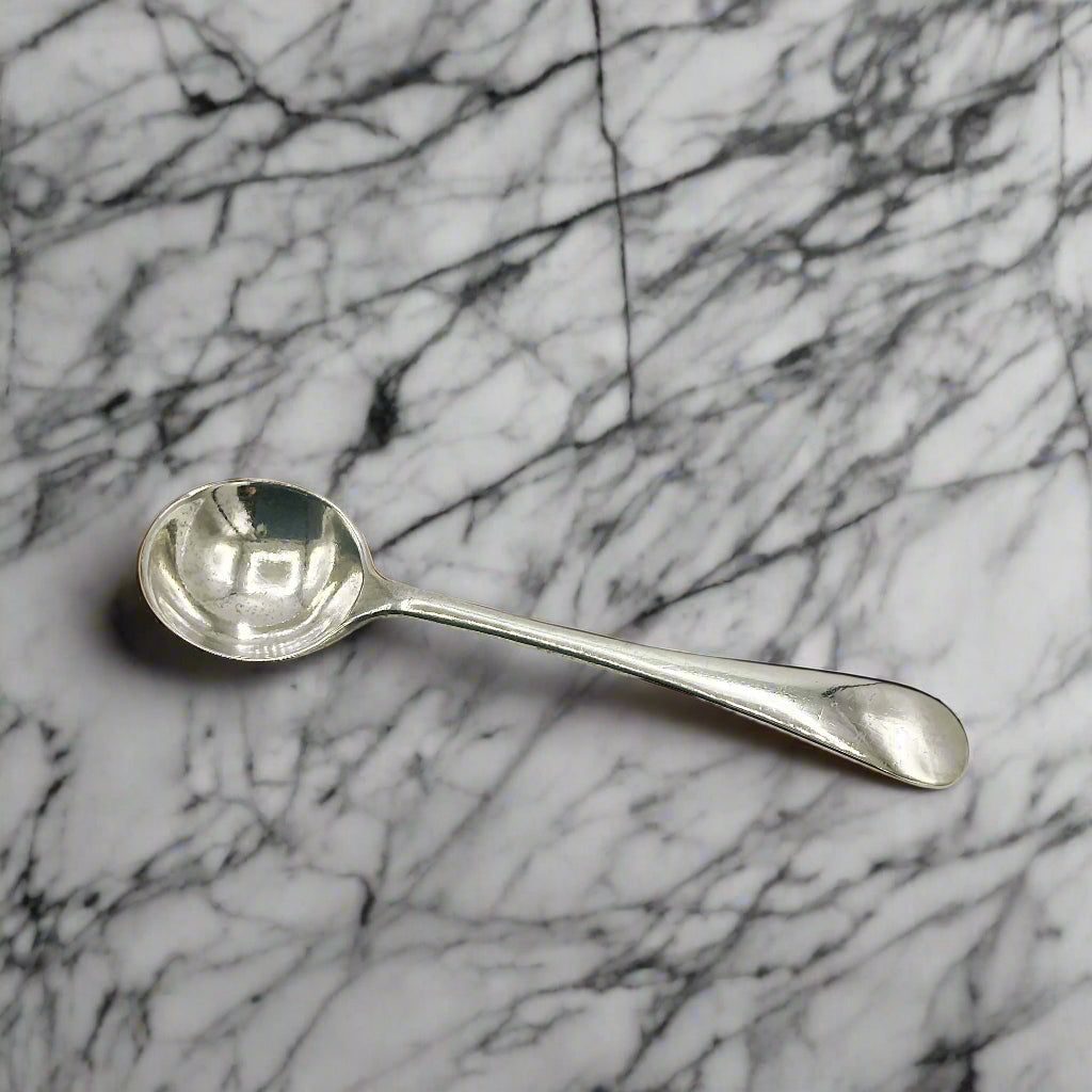 Silver spoon on a marble worktop
