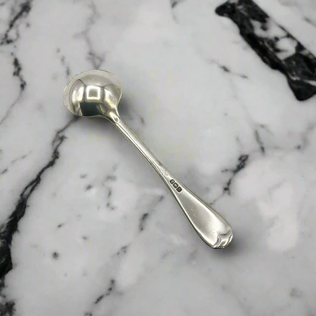 Silver spoon upside down on a marble worktop