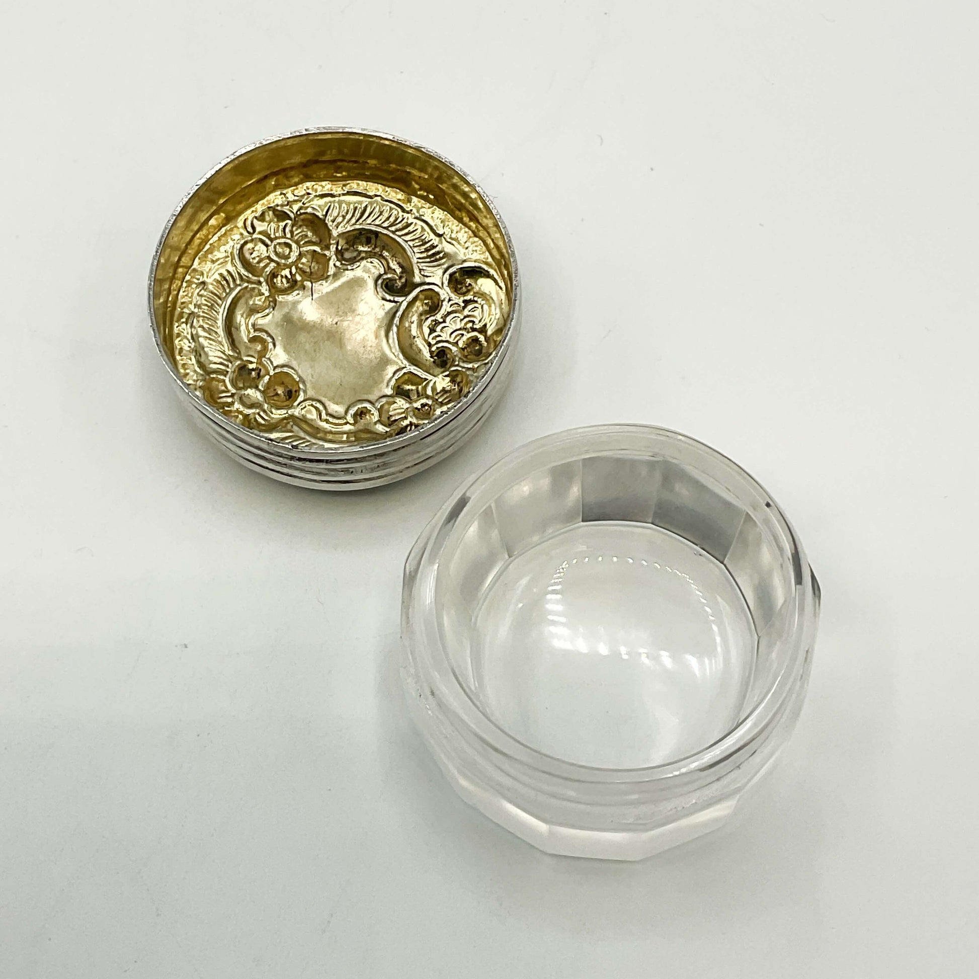 Clear glass jar with a gold lid on a white background