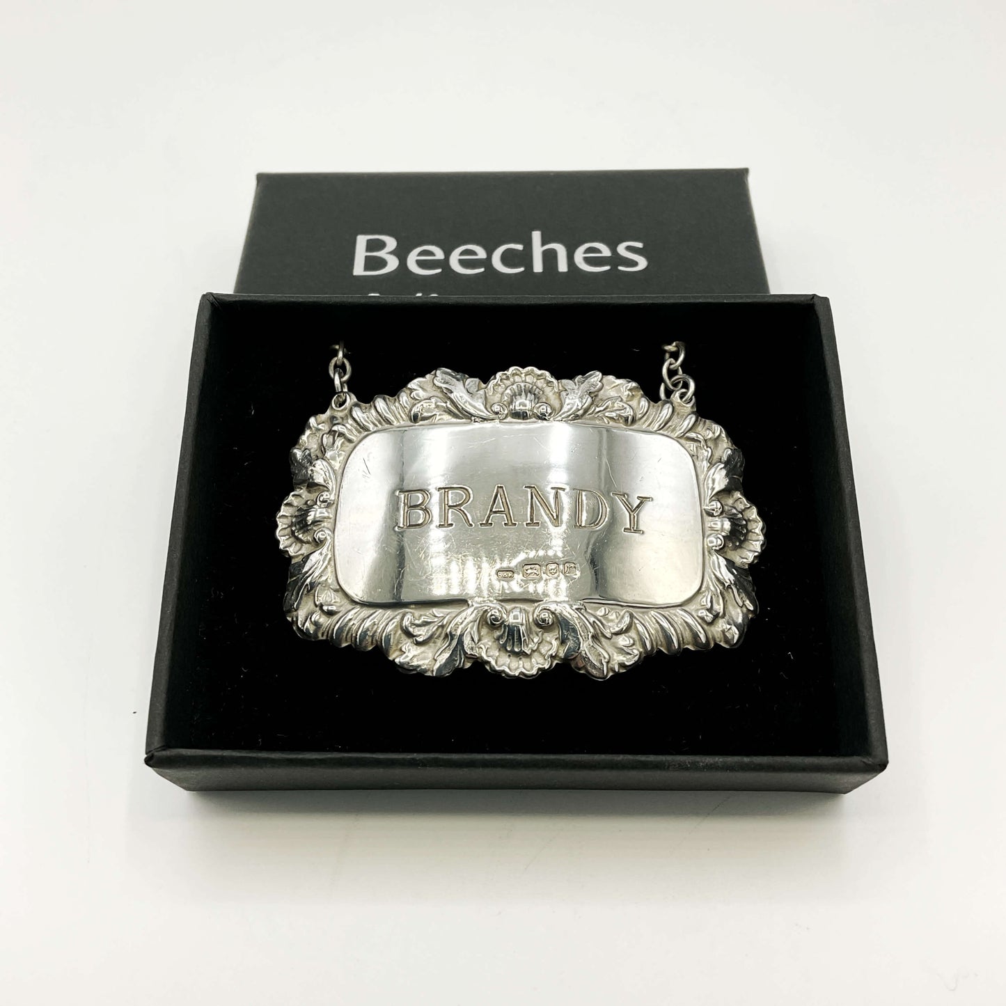 Silver 'BRANDY' decanter label in a black box with 'Beeches Vintage’ branding and a white background 