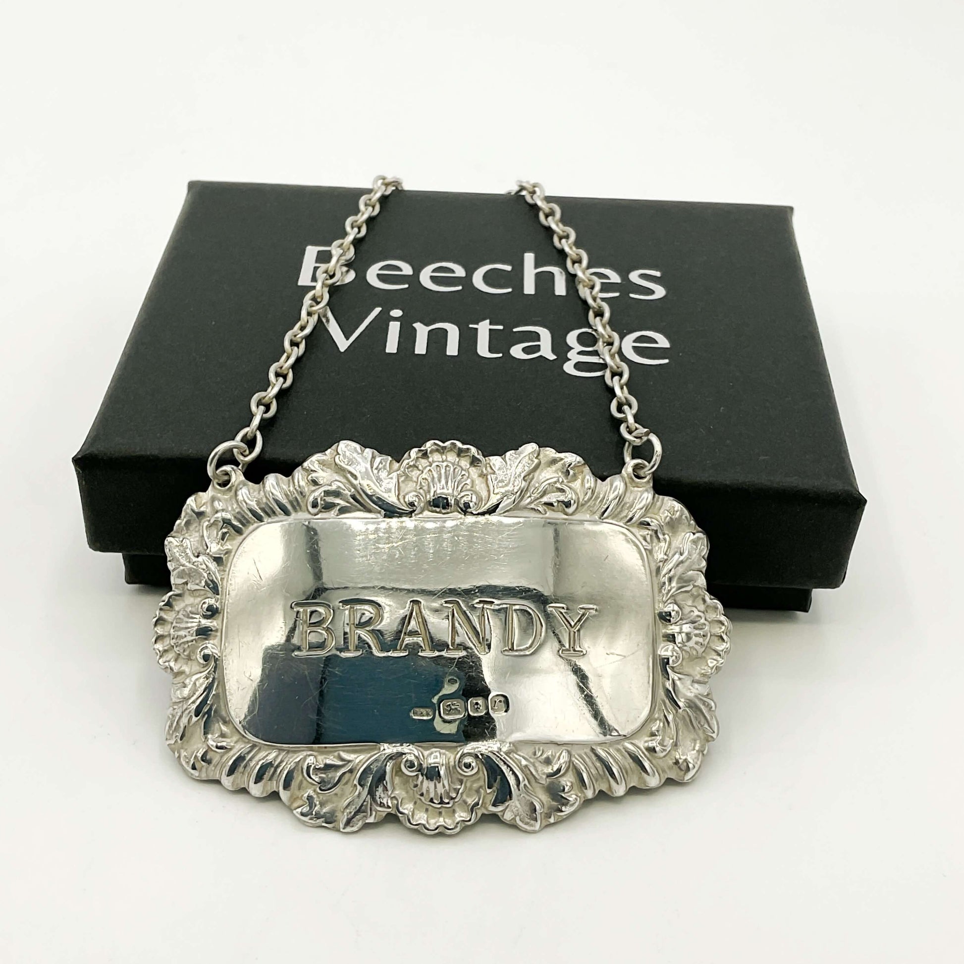 Silver brandy decanter label on a white background with 'Beeches Vintage' packaging and a white background.
