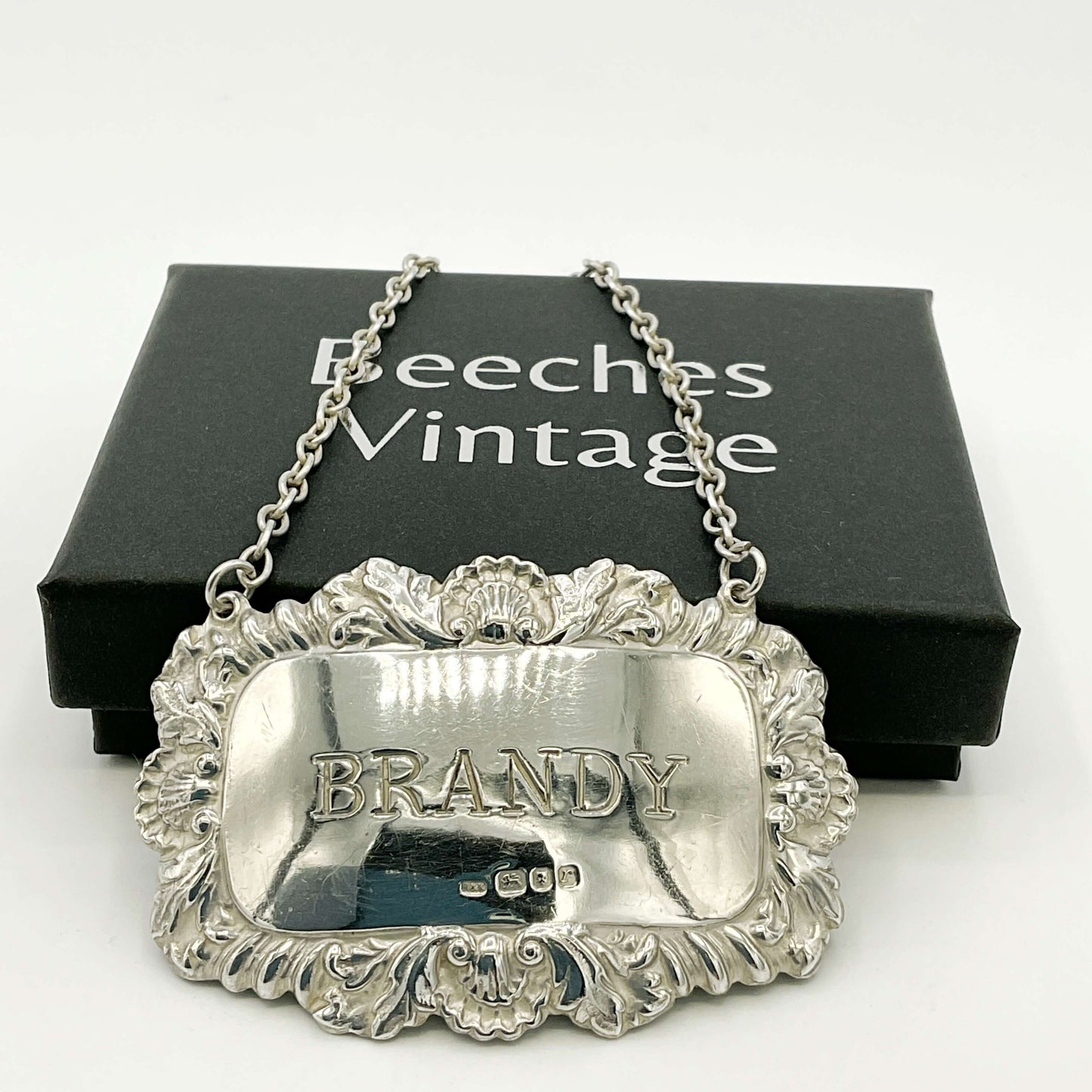 Silver 'BRANDY' decanter label with ornate design on a white background, featuring 'Beeches Vintage' packaging.