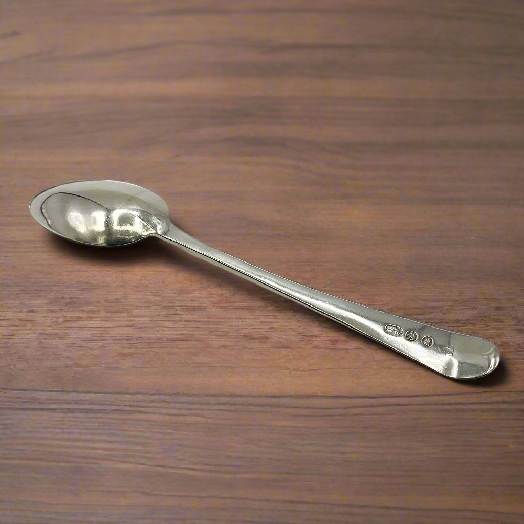 Silver spoon on a wood table
