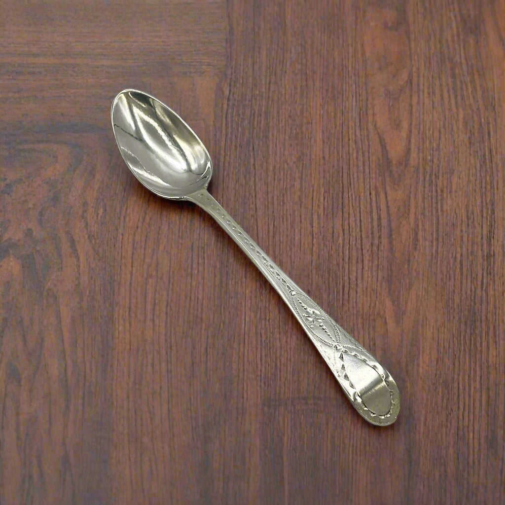 Silver spoon on a wood table
