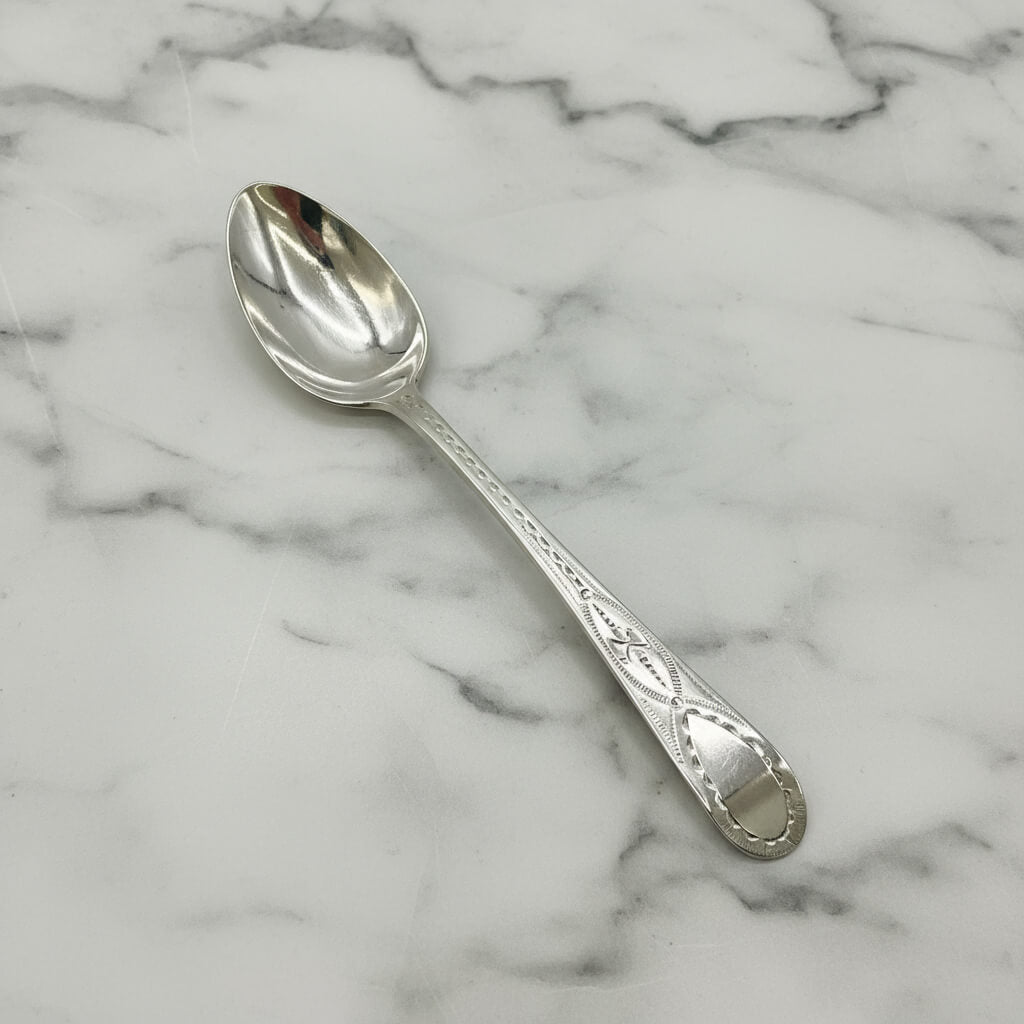 Silver spoon on a marble surface