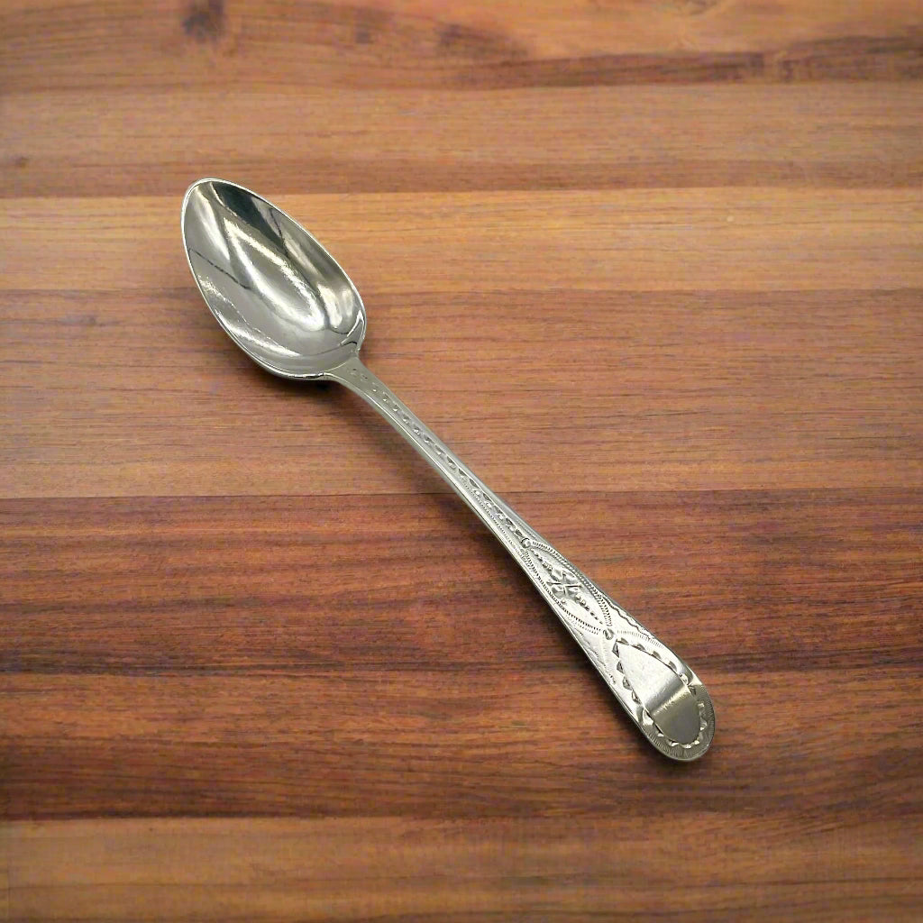 Silver spoon on a wooden table