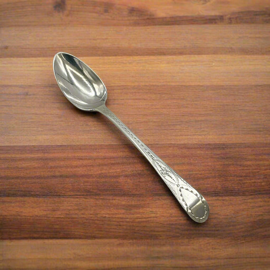Silver spoon on a wooden table