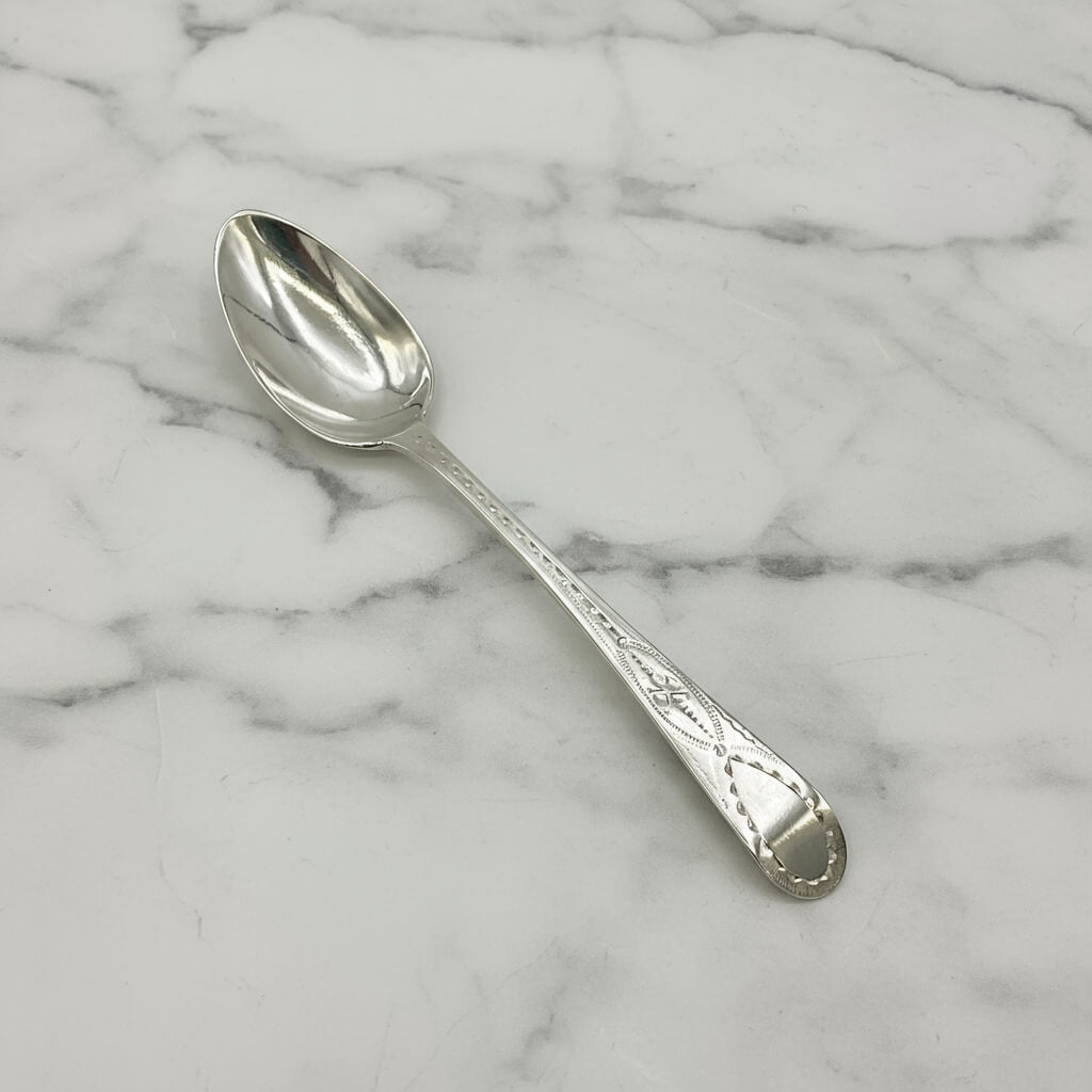 Silver spoon on a marble surface