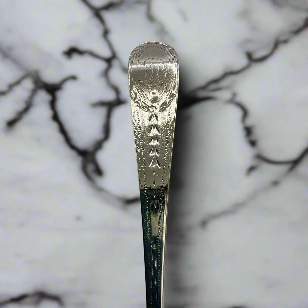 Decorative silver spoon on a marble background